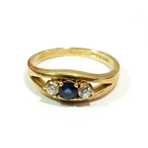 608 - A 9 carat gold ring set sapphire flanked by white stones, size L to M