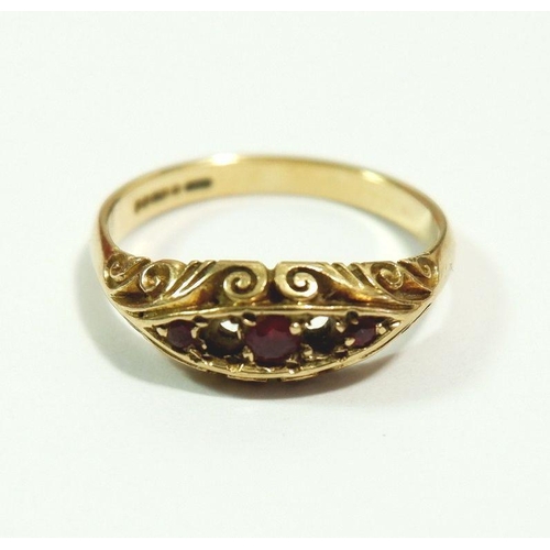 621 - A 9 carat gold ring set rubies - two deficient, size L to M, 2.5g