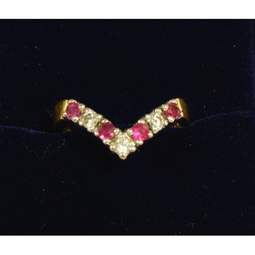 627 - An 18 carat gold ruby and diamond wishbone ring, size K