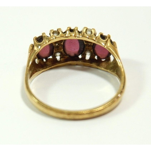 637 - A 9 carat gold ring set three cabochon cut pink stones and six white stones, size S to T