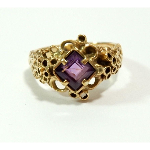 654 - A 9 carat gold ring set amethyst in 'pitted' setting, size Q, 5.4g