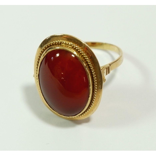 657 - A 14 carat gold ring set orange stone, size T to U