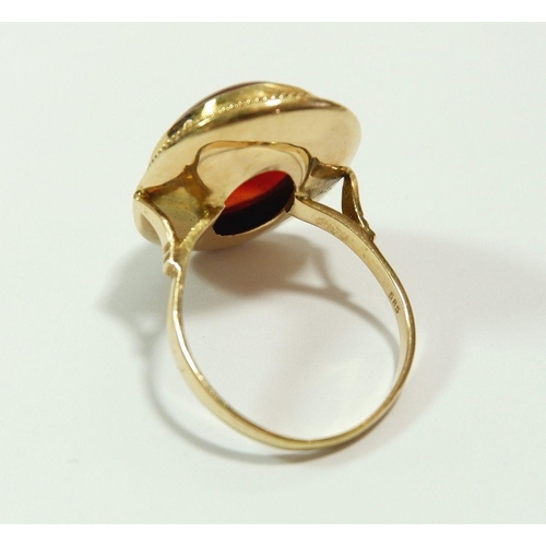 657 - A 14 carat gold ring set orange stone, size T to U