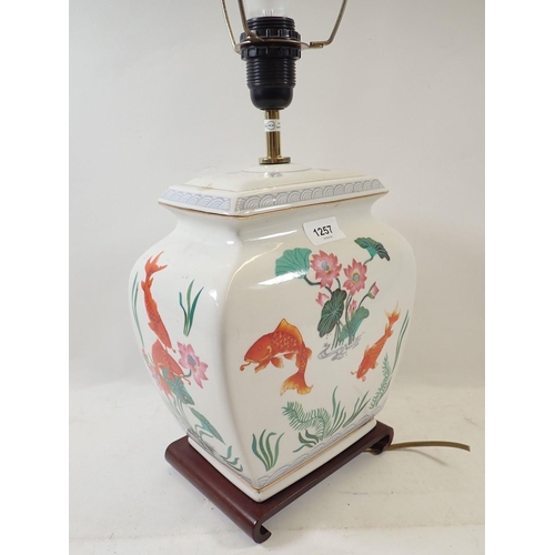 1257 - A Chinese table lamp painted golden carp, 28cm high