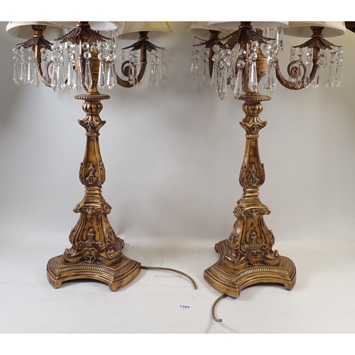 1304 - A pair of gilt metal five branch candelabrum style table lamps with shades and lustres, overall heig... 