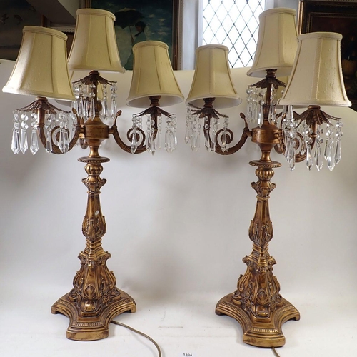 1304 - A pair of gilt metal five branch candelabrum style table lamps with shades and lustres, overall heig... 