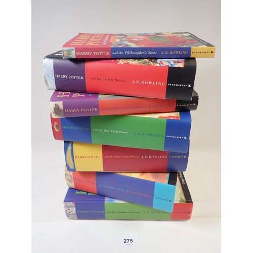 275 - A collection of six Harry Potter hardback books and one paperback