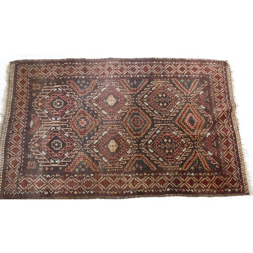 1297 - A Turkoman style rug with lozenge and hooked medallions on a brown ground 202 x 125cm