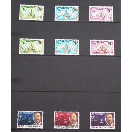 165 - Turks & Caicos Is: Black 14 page Hagner album of QV-QEII defin & commem. Wmk, overprint & other vari... 