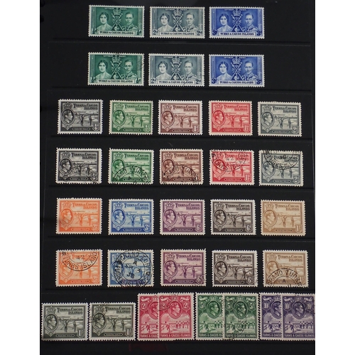 165 - Turks & Caicos Is: Black 14 page Hagner album of QV-QEII defin & commem. Wmk, overprint & other vari... 