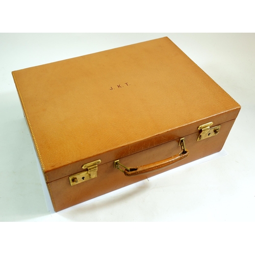 566 - A Cartier pigskin gentleman's toiletry case fitted with glass and lacquer toiletry bottles, jars and... 