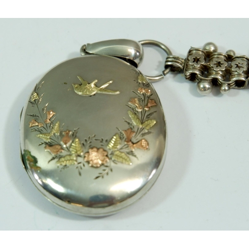 599 - A Victorian silver locket with coloured gold inlay to front depicting bird and flowers, on original ... 