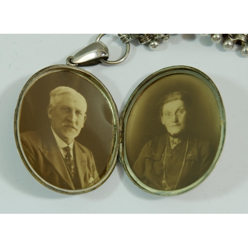 599 - A Victorian silver locket with coloured gold inlay to front depicting bird and flowers, on original ... 