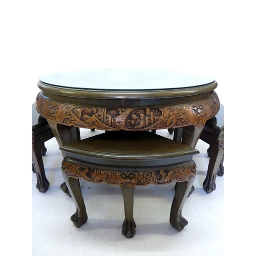 1002 - A Chinese circular occasional table and 4 1/4 nest tables all with elaborate carved decoration