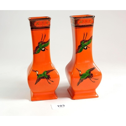 103 - A pair of Shelley vases painted storks on an orange ground, 17.5cm