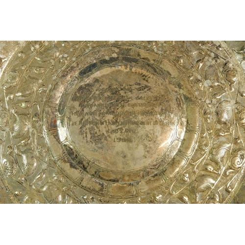 198 - A Ceylonese white metal salver with embossed decoration, with inscription dated 1966, 397g