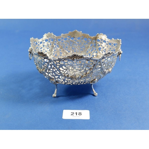 218 - An embossed and pierced silver dish with clear glass liner, Chester import hallmarks for 1909 by BM,... 