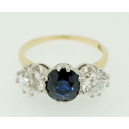 237 - A fine 18 carat gold ring set central sapphire (1.99ct) flanked by two diamonds (85pts each) size O,... 