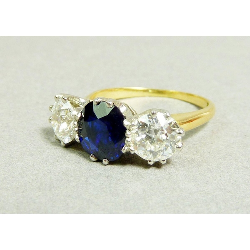 237 - A fine 18 carat gold ring set central sapphire (1.99ct) flanked by two diamonds (85pts each) size O,... 