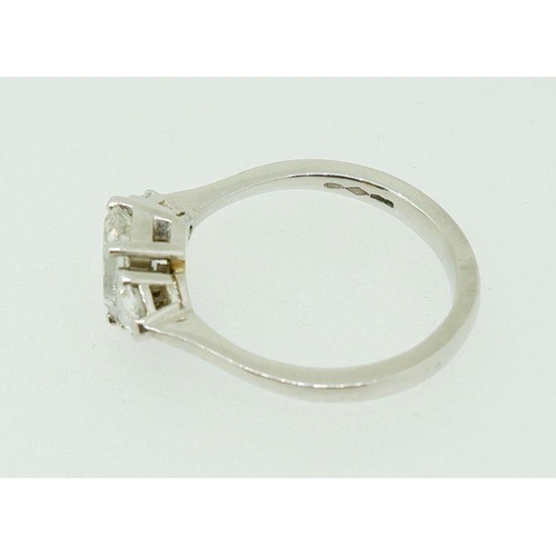 243 - A fine platinum ring set central emerald cut diamond flanked by two trilliant cut diamonds, size N, ... 