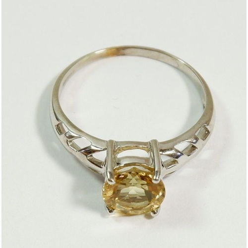 248 - A 9 carat white gold citrine ring on pierced shoulders, size T