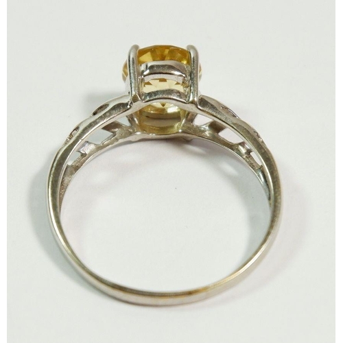 248 - A 9 carat white gold citrine ring on pierced shoulders, size T