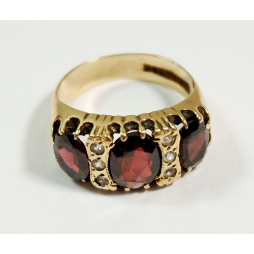 251 - A 9ct gold ring set three garnets and six small white stones, size K-L