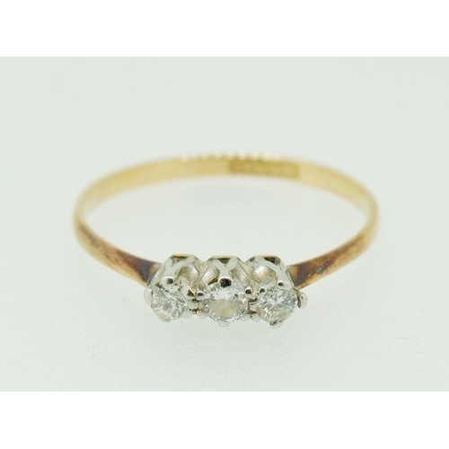 253 - An 18ct gold and platinum three stone diamond ring, size O