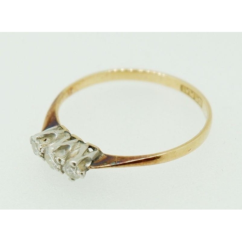 253 - An 18ct gold and platinum three stone diamond ring, size O