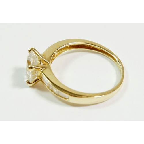 261 - A 14 carat gold dress ring set central white stone on baguette cut shoulders, size O to P