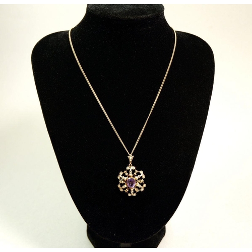 280 - An Edwardian 9 carat gold amethyst and seed pearl pendant/brooch on 9 carat gold chain in original b... 