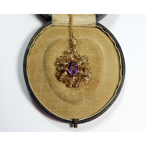 280 - An Edwardian 9 carat gold amethyst and seed pearl pendant/brooch on 9 carat gold chain in original b... 