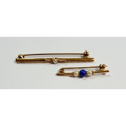 285 - A 9 carat gold bar brooch set pearl, boxed and a yellow metal bar brooch set blue stone and pearl