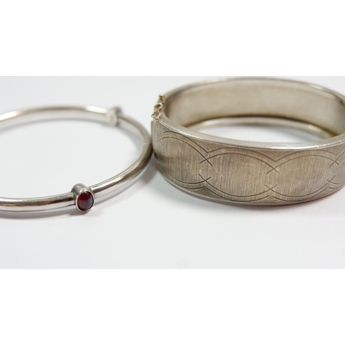 305 - Two silver bangles, one set stones