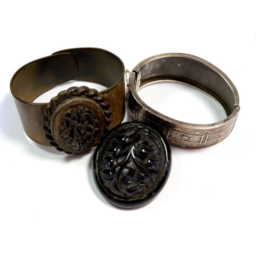 306 - A Victorian carved jet brooch, two Victorian bangles, a silver bangle and a carved bone necklace