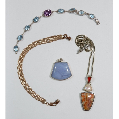 314 - Two stone set silver pendants, a silver bracelet and a woven silver gilt bracelet