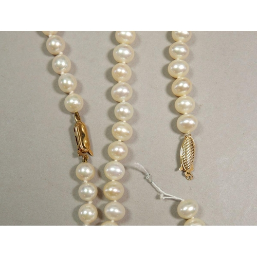 318 - Two strings of pearls with a gold clasp, string a/f