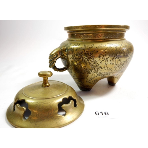 616 - A small Chinese brass censer with incised decoration and elephant handles, 14cm tall