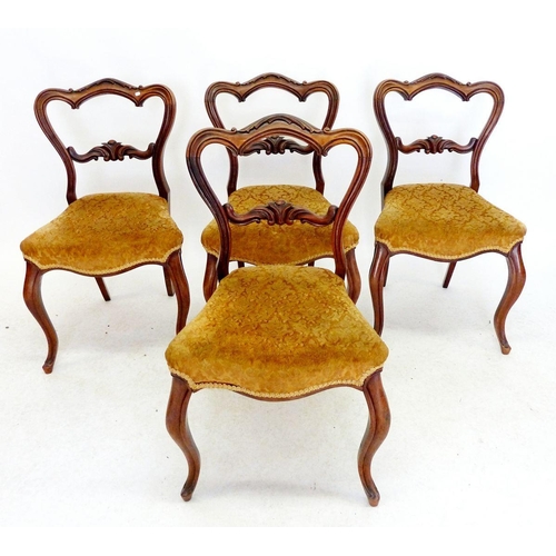 995 - A set of four Victorian mahogany dining chairs with scrollwork carved backs