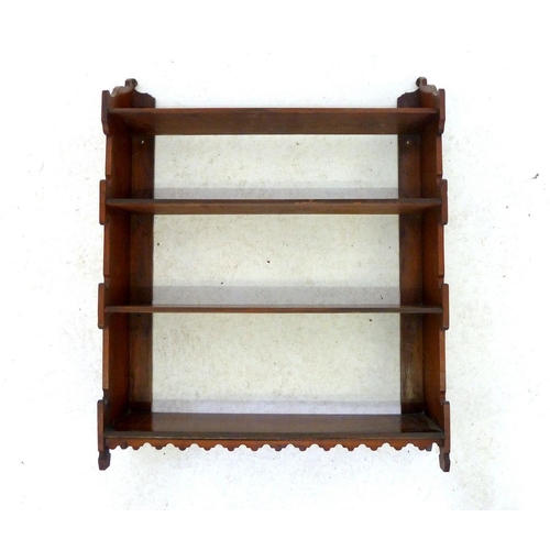 996 - A Victorian walnut open wall shelf with carved decorative freize