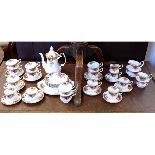 12 - A Royal Albert 'Country Roses' tea and coffee service comprising: teapot, five bowls, two sugar bowl... 