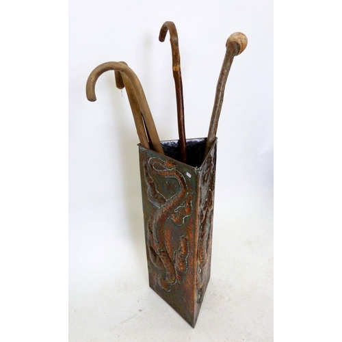 1090 - An Arts and Crafts copper triangular stick stand embossed lizard, 59cm tall including walking sticks... 