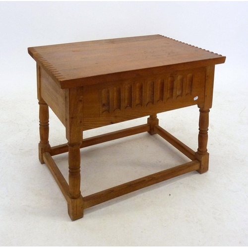 1098 - A light oak carved rise top occasional table, 58cm wide