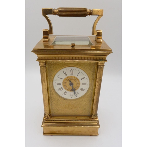 1101 - A Victorian brass carriage clock with four columns and repeater striking movement, 16cm to top of ca... 