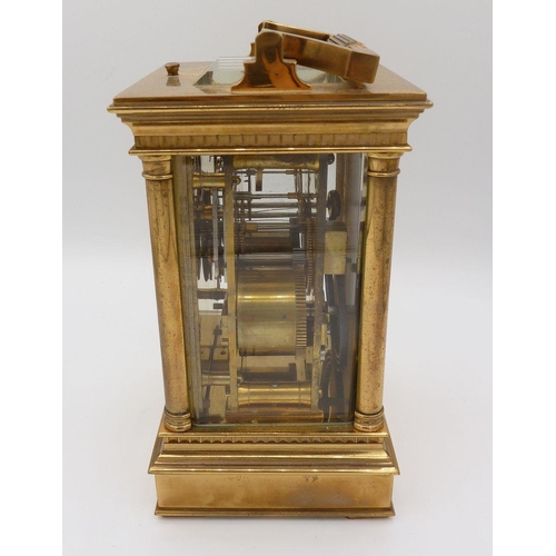 1101 - A Victorian brass carriage clock with four columns and repeater striking movement, 16cm to top of ca... 