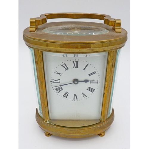 1102 - An Edwardian brass oval carriage clock, 11.5cm to top of case