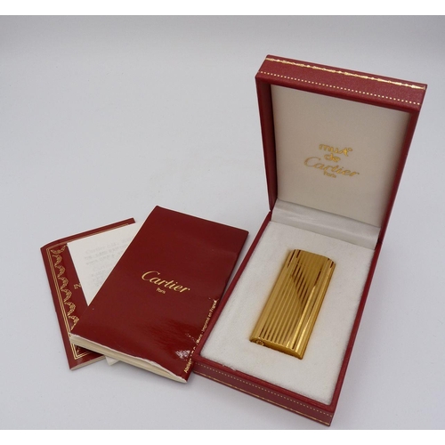 1115 - A gold plated Cartier cigarette lighter, boxed