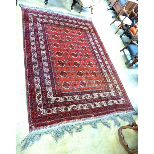 1127 - A Turkoman carpet with three rows of guls on a red ground within multiple borders, 289 x  213cm