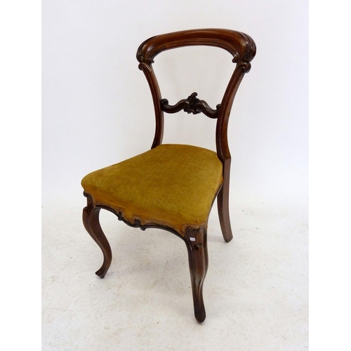 1130 - A Victorian mahogany balloon back chair with carved decoration