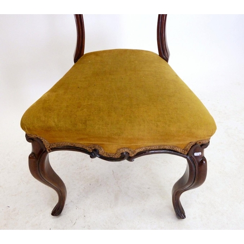 1130 - A Victorian mahogany balloon back chair with carved decoration